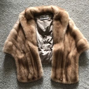 Genuine mink stole/poncho with slit pockets.